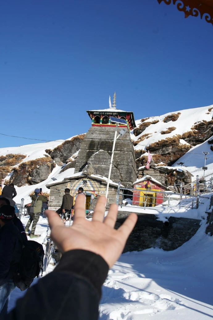 person in black jacket on snow covered mountain during daytime